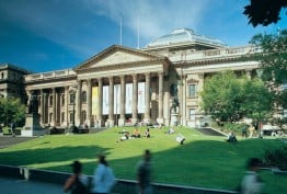 Colour photo of State Library Victoria facade and lawn on a sunny day