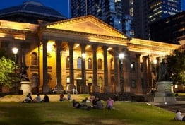 Library facade forecourt and lawns at night