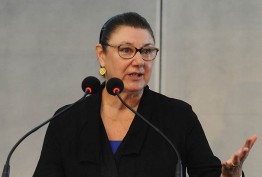 Susan Scollay Susan Scollay speaking behind a lectern