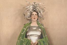 Velvet Iron Ashes A woman in a vibrant hat and green cape