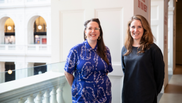 Two women standing in the dome and smiling