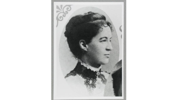 Black and white side profile photograph of Constance Stone as a young woma, wearing her hair up in a bun.