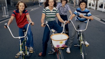 4 teens in 70s clothing on dragster bikes