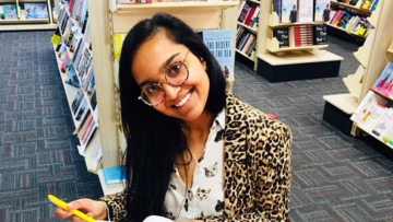 Woman smiling and signing books