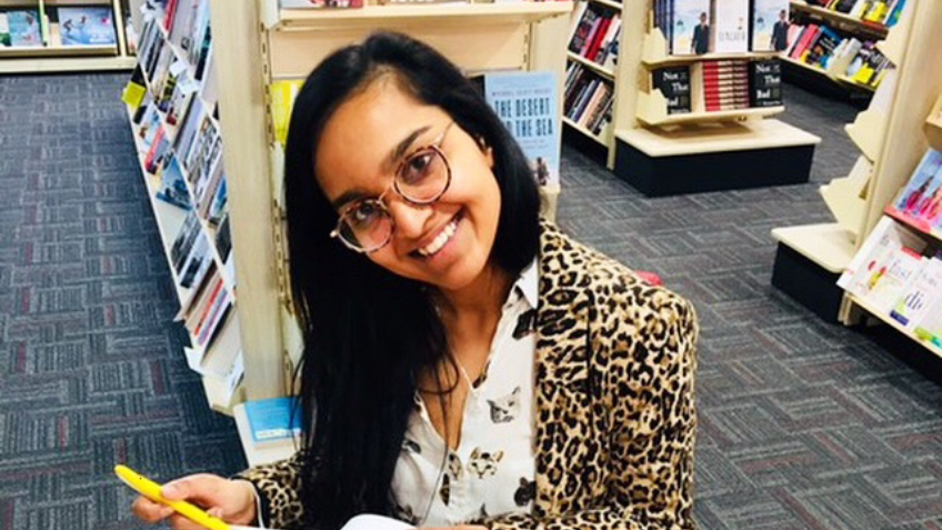 Woman smiling and signing books
