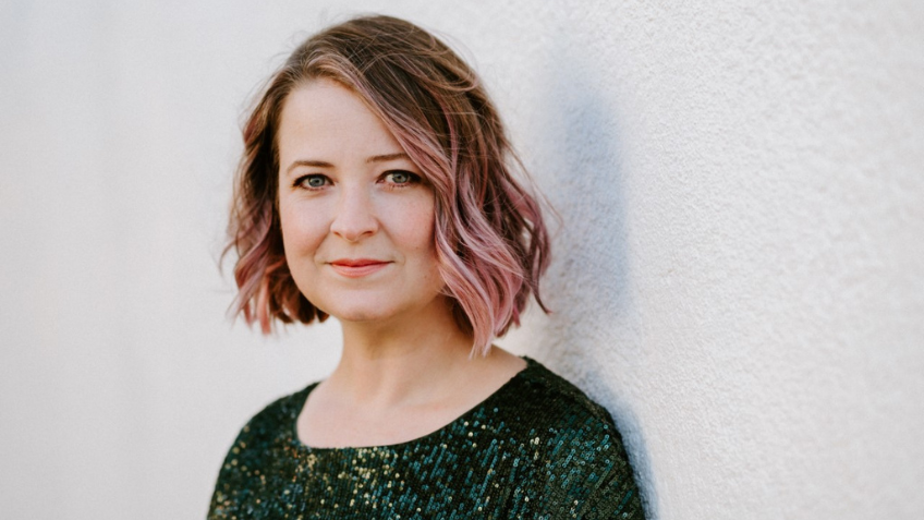 Author Lili Wilkinson with pink highlights and wearing a green sequin top.