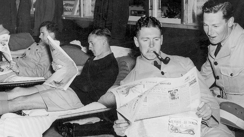 Photo of soldiers resting in their quarters and reading newspapers