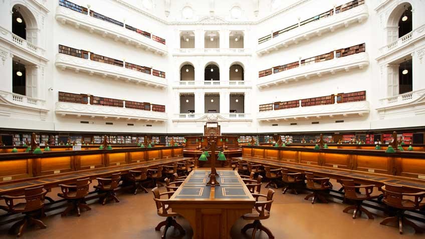 Heritage wooden desks and chairs in the La Trobe Reading Room