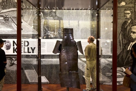 View of Ned Kelly armour on display in the Redmond Barry Reading Room. The armour is in a glass case.