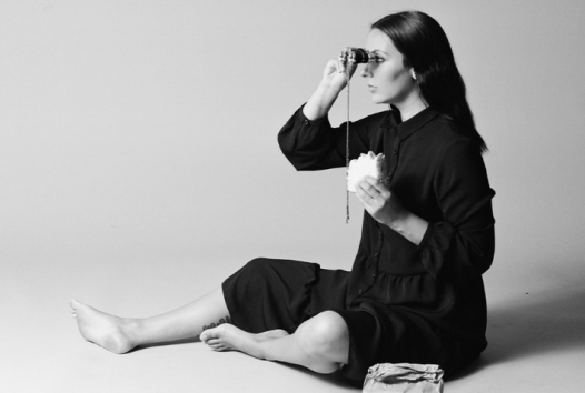 Black and white photo of a woman looking through binoculars