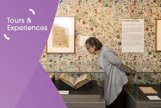 Image of a woman with chin length hair and in a striped top and grey cardigan viewing rare books in cases in the World of the Book exhibition at the Library. On the left is a purple graphic overlay with white text that says 'tours and experiences'.